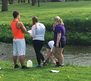 Students testing water at park