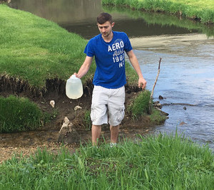 Student gathering water for testing